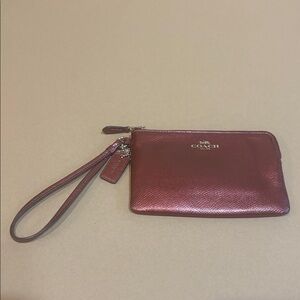 Red metallic Coach wristlet with zipper closure + ball & chain bag tag attached